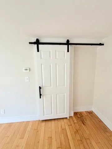 a view of a room with wooden floor