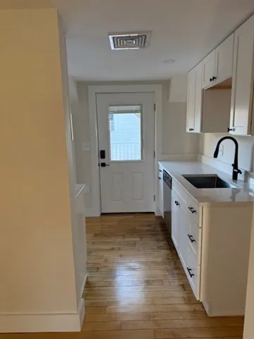 a kitchen with granite countertop a sink and a stove top oven