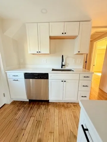 a kitchen with a refrigerator and a stove top oven