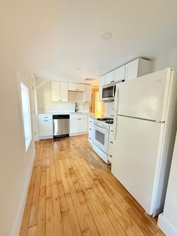 244 Main Street, Unit 2 North Andover, MA 01845 - Photo 10 of 36 a kitchen with a refrigerator and a stove top oven
