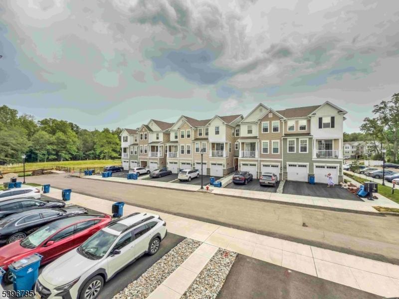 a view of a city that has tall buildings and cars parked