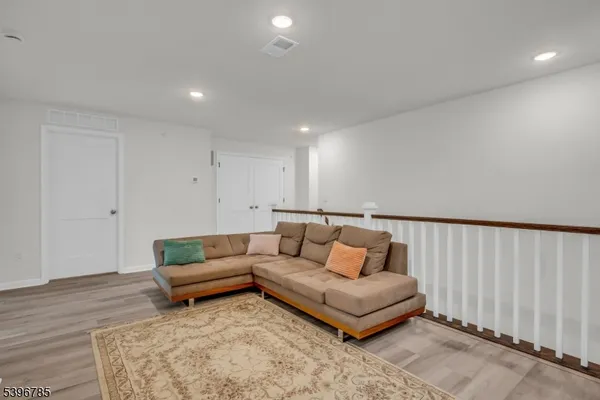 a living room with furniture and a rug