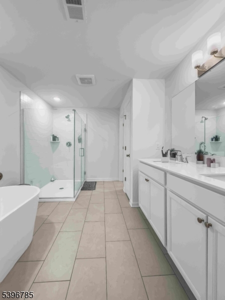 204 Honeysuckle Lane Warren, NJ 07059 - Photo 21 of 30 a bathroom with a double vanity sink a toilet and a bathtub