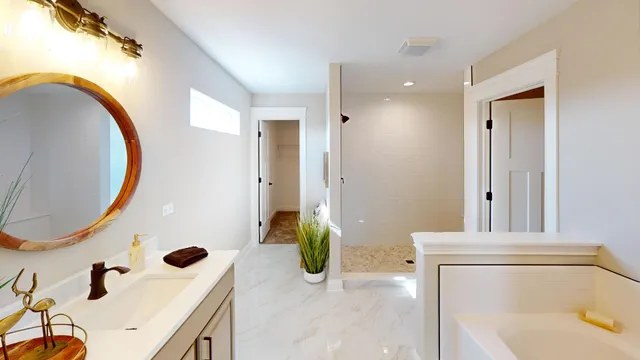 a bathroom with a tub sink and mirror