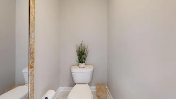 a white toilet sitting next to a shower