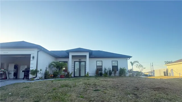 a front view of a house with a yard