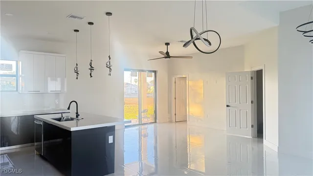 a view of a sink and dishwasher with wooden floor