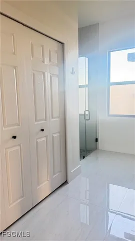 a patio with table and chairs and potted plants