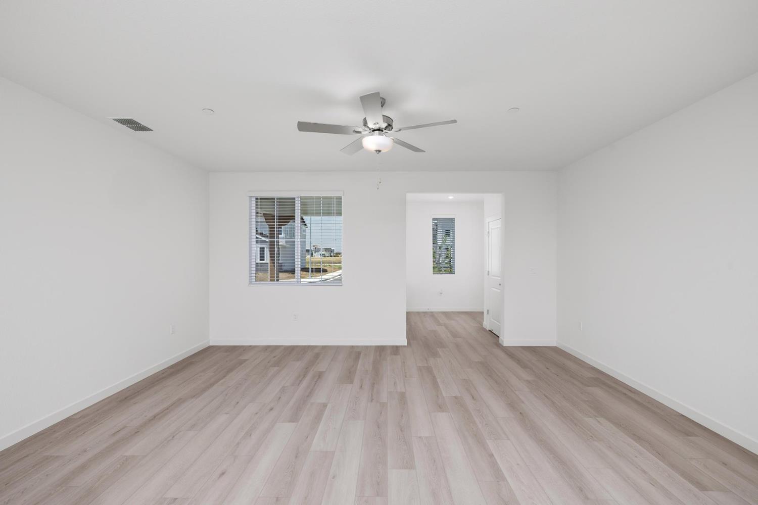 820 Helmsley Lane Patterson, CA 95363 - Photo 6 of 18 wooden floor in an empty room with a window