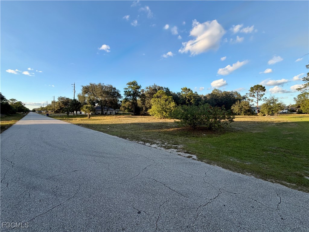 1049-1051 Meadow Road Lehigh Acres, FL 33973 - Photo 3 of 5 a view of a road and yard