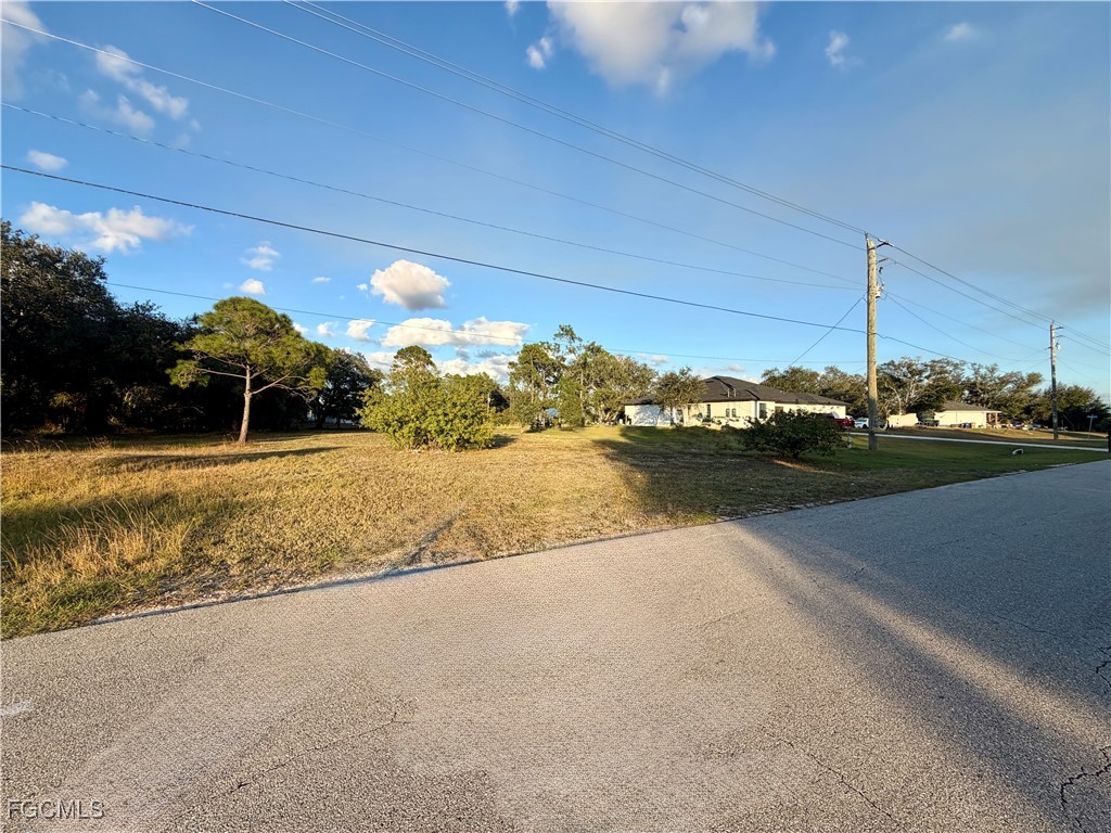 1049-1051 Meadow Road Lehigh Acres, FL 33973 - Photo 5 of 5 a view of a lake with a big yard