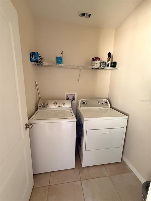 7843 Hardenton Street Windermere, FL 34786 - Photo 13 of 19 a utility room with dryer and washer