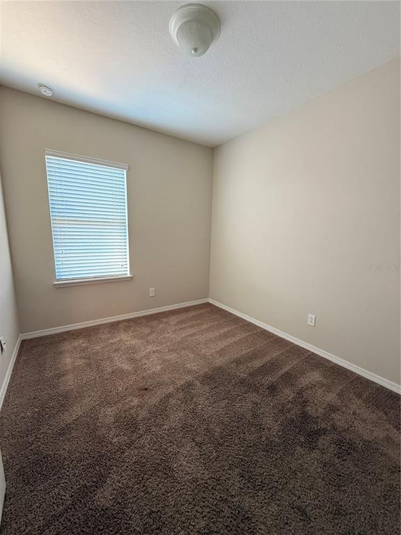 7843 Hardenton Street Windermere, FL 34786 - Photo 17 of 19 an empty room with a space and a window