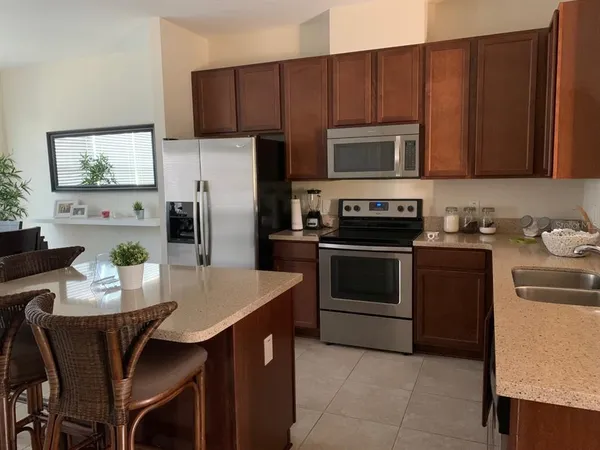 a kitchen with a sink stove and refrigerator