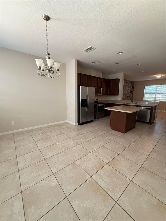 7843 Hardenton Street Windermere, FL 34786 - Photo 9 of 19 a kitchen with stainless steel appliances a sink and cabinets