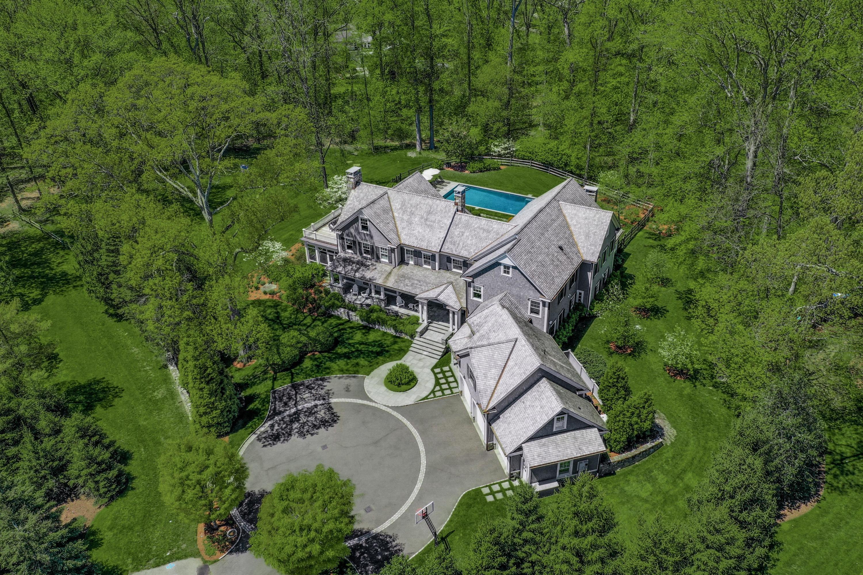 an aerial view of a house with a yard