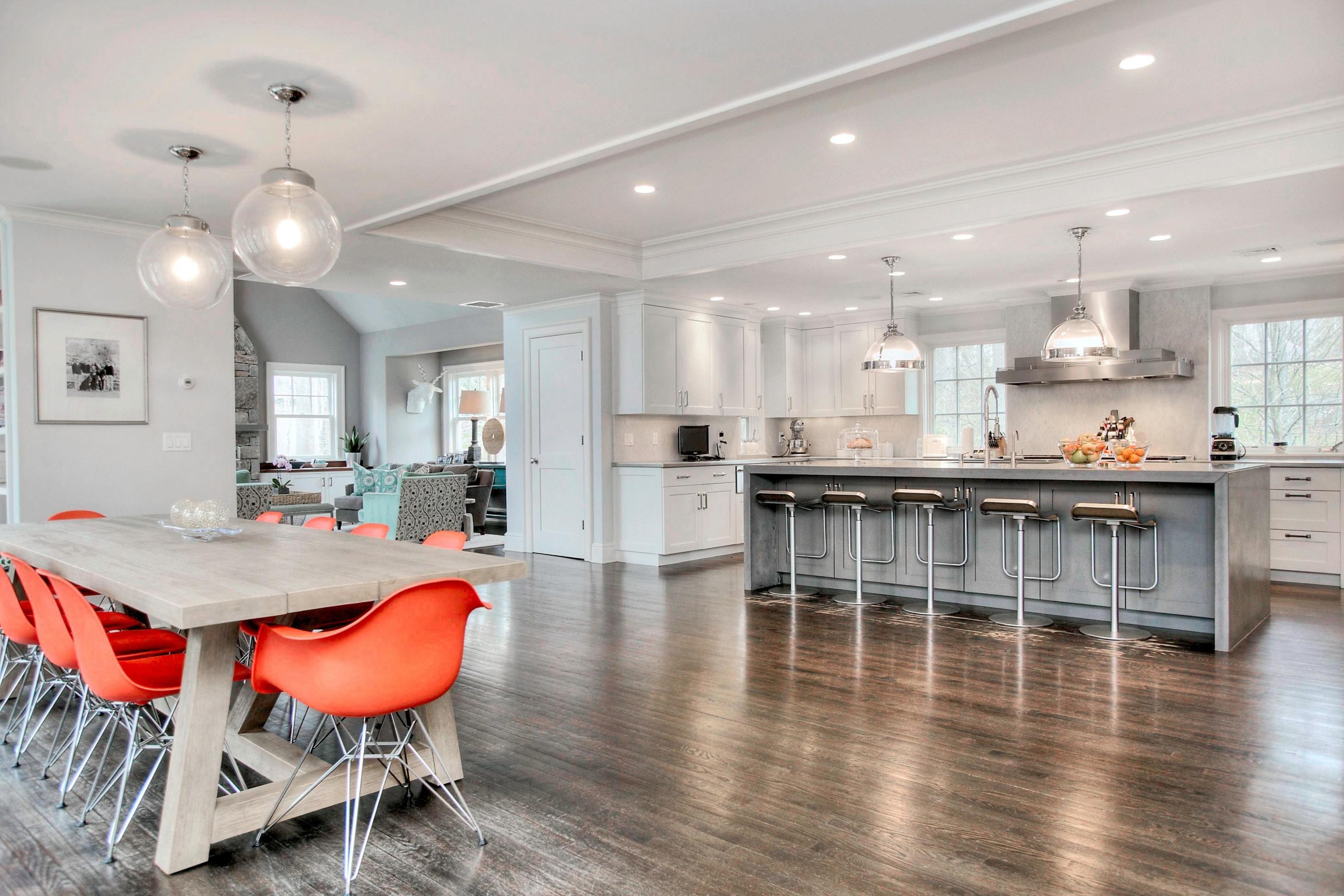 24 Cross Road Darien, CT 06820 - Photo 20 of 53 an open kitchen with granite countertop a dining table chairs stove a refrigerator and cabinets