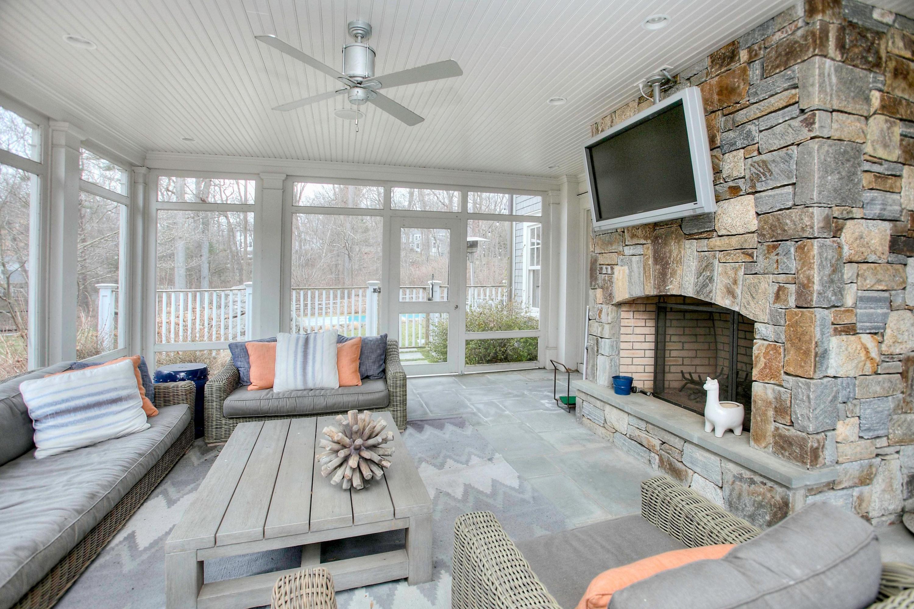 24 Cross Road Darien, CT 06820 - Photo 22 of 53 a living room with furniture a flat screen tv and a fireplace