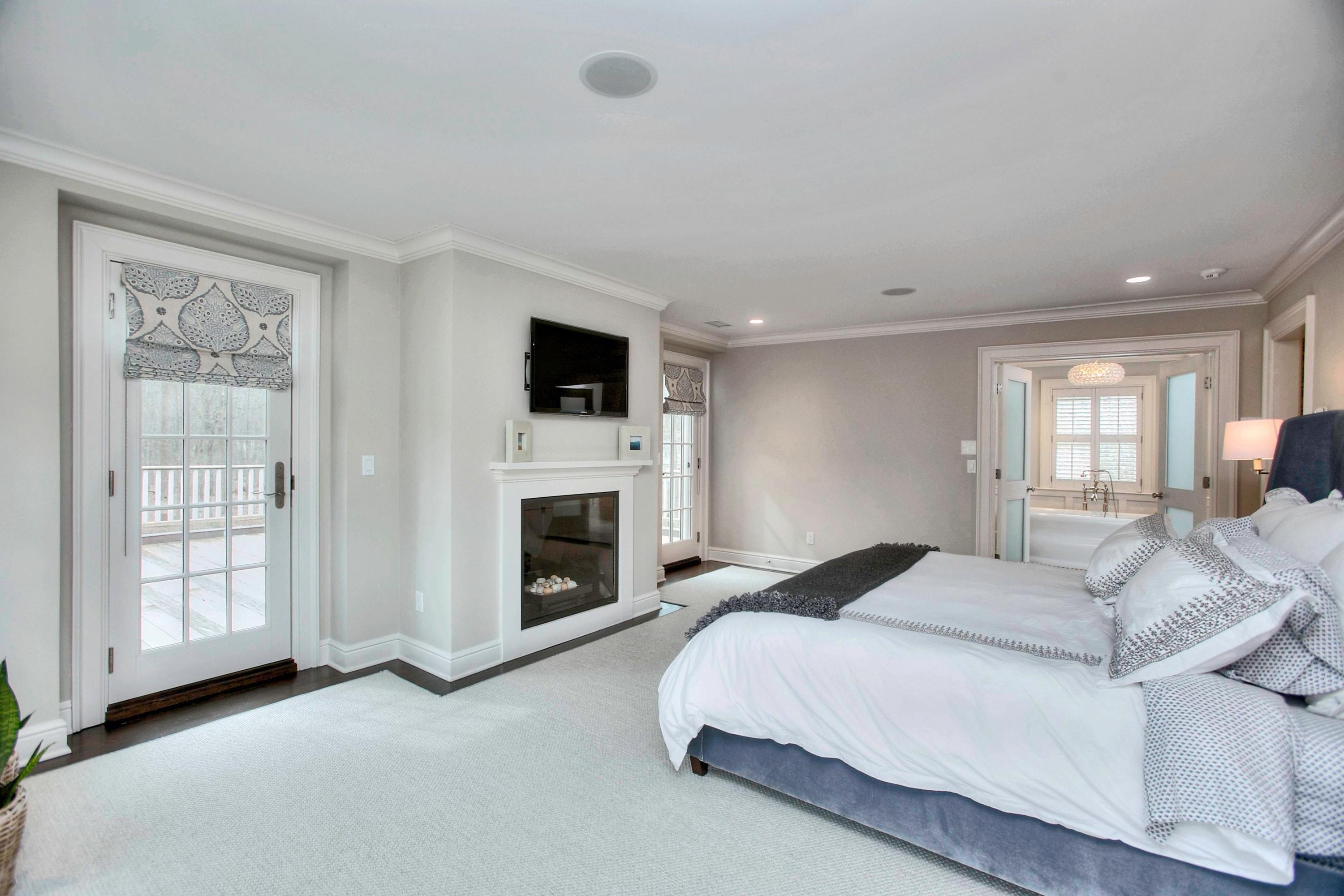 24 Cross Road Darien, CT 06820 - Photo 36 of 53 a spacious bedroom with a bed and a flat screen tv