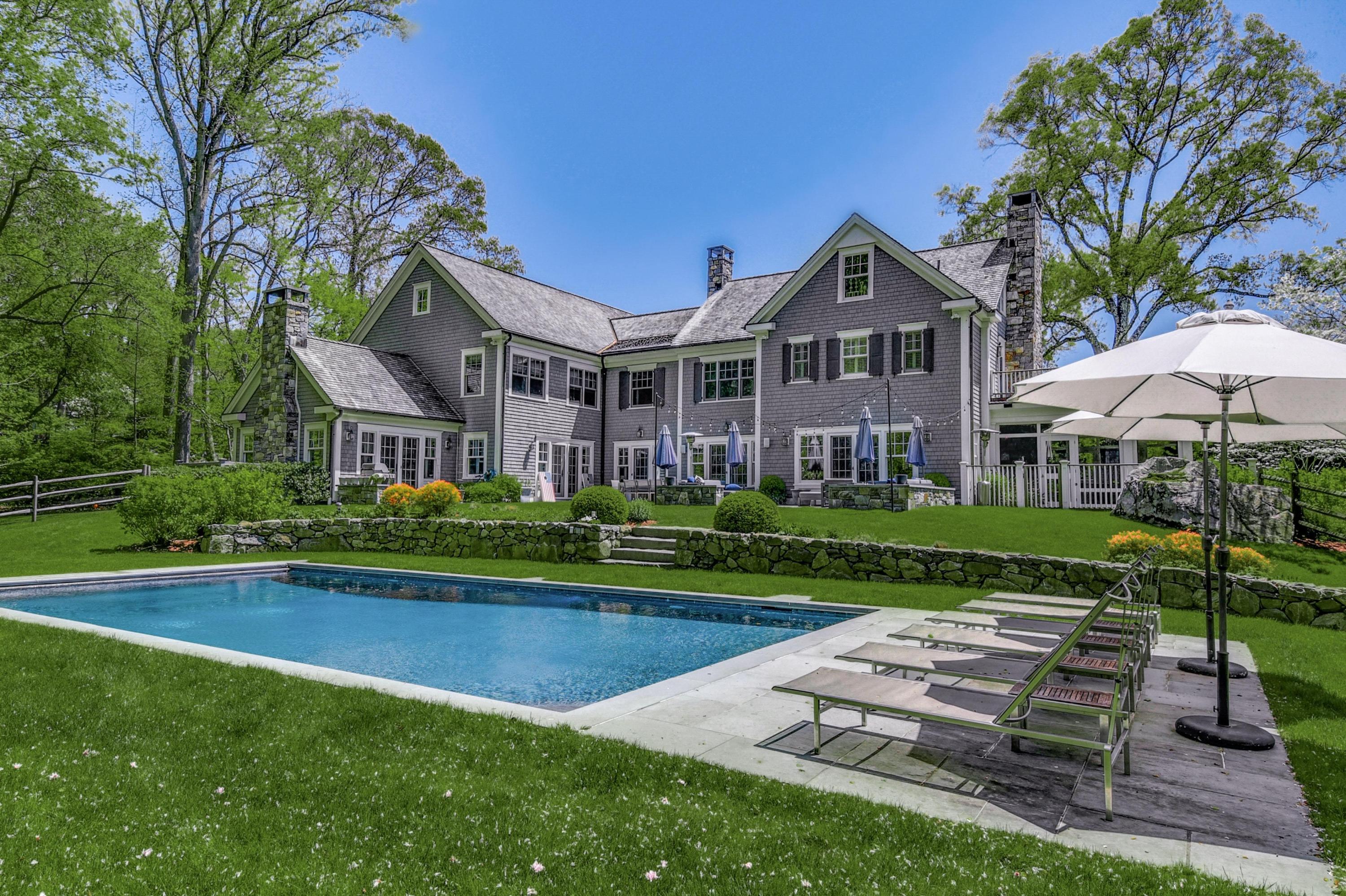 24 Cross Road Darien, CT 06820 - Photo 49 of 53 a front view of a house with garden