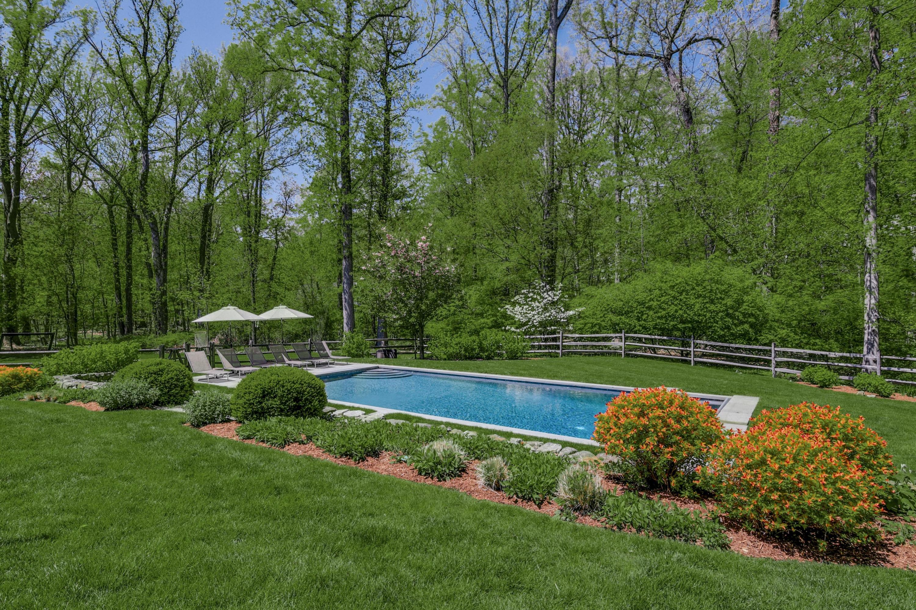 24 Cross Road Darien, CT 06820 - Photo 51 of 53 a view of a swimming pool with a garden