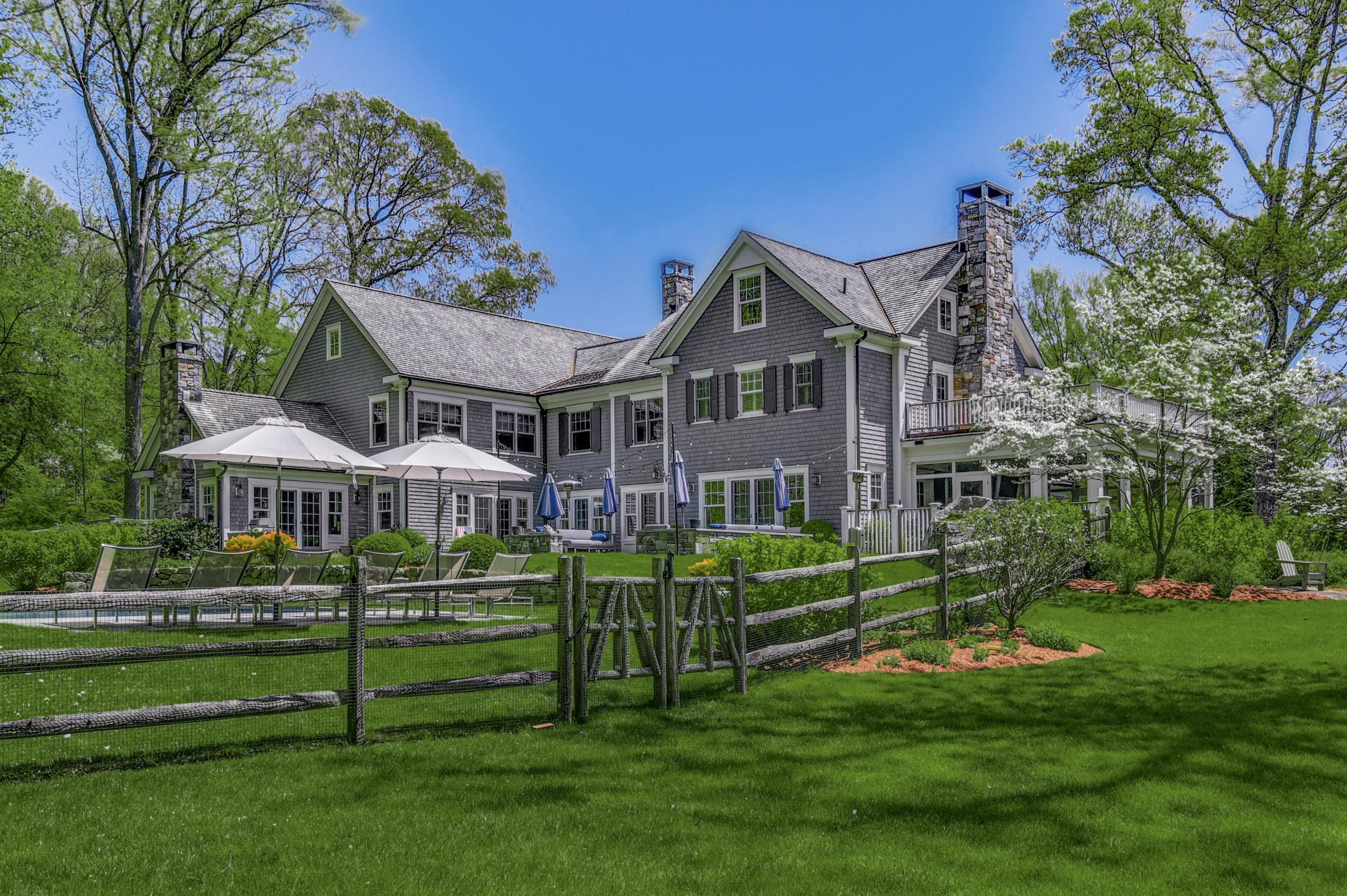 24 Cross Road Darien, CT 06820 - Photo 52 of 53 a front view of a house with a yard table and plants