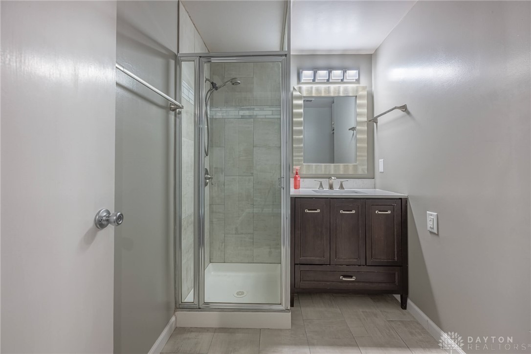 467 West Rahn Road Dayton, OH 45429 - Photo 26 of 41 This clean bathroom features a glass-enclosed shower and a vanity with ample storage.