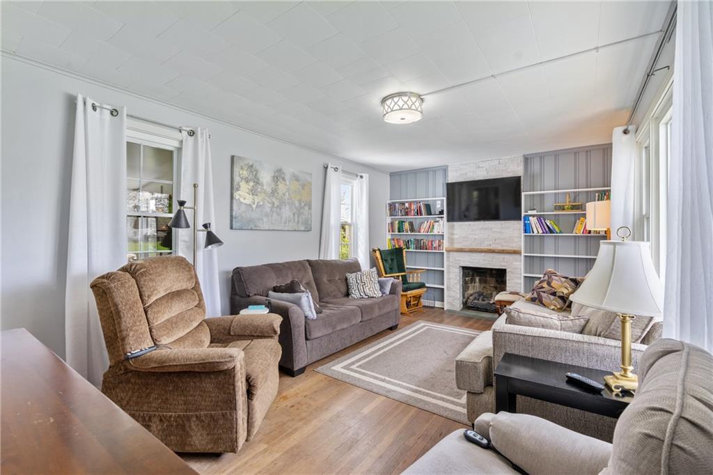 594 Whitestown Road Butler, PA 16001 - Photo 2 of 25 a living room with furniture a fireplace and a flat screen tv