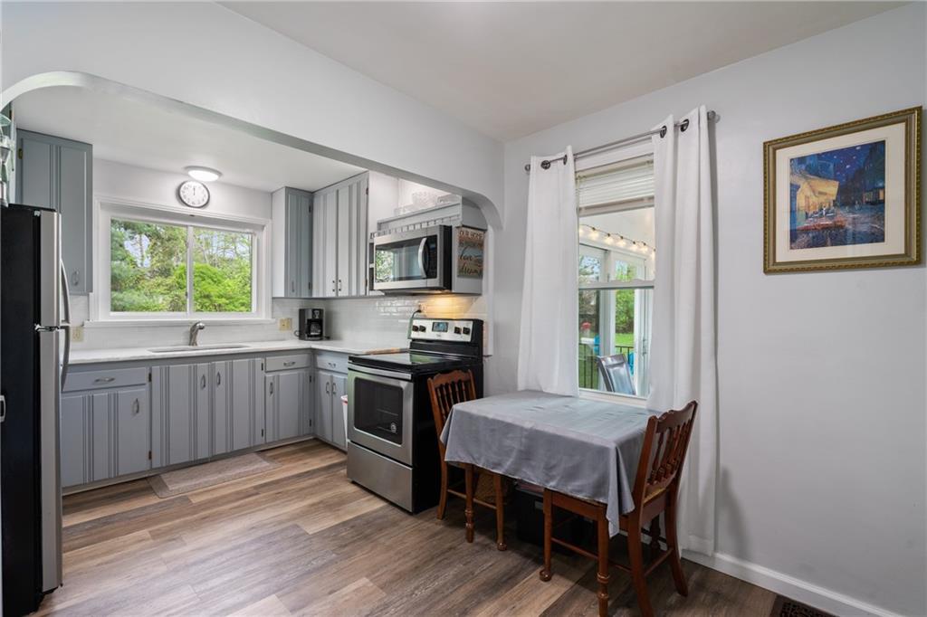 594 Whitestown Road Butler, PA 16001 - Photo 23 of 25 a kitchen with a table chairs refrigerator and microwave