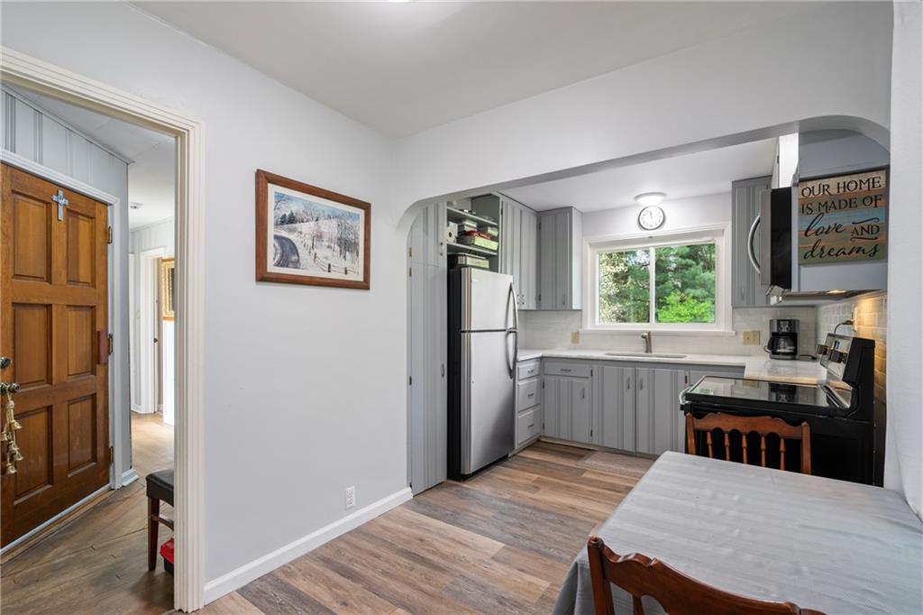 594 Whitestown Road Butler, PA 16001 - Photo 4 of 25 a kitchen with a wooden floor and a refrigerator
