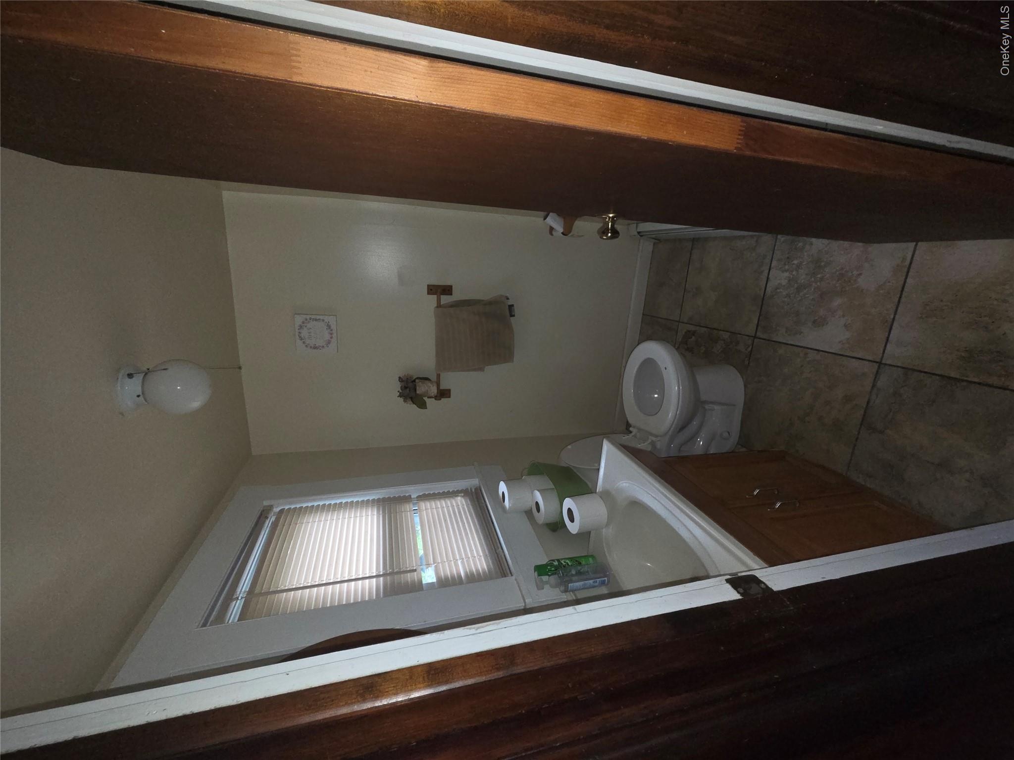 11 Eagle Valley Road, Unit 7 Sloatsburg, NY 10974 - Photo 13 of 24 a bathroom with a granite countertop toilet a sink a mirror and a shower