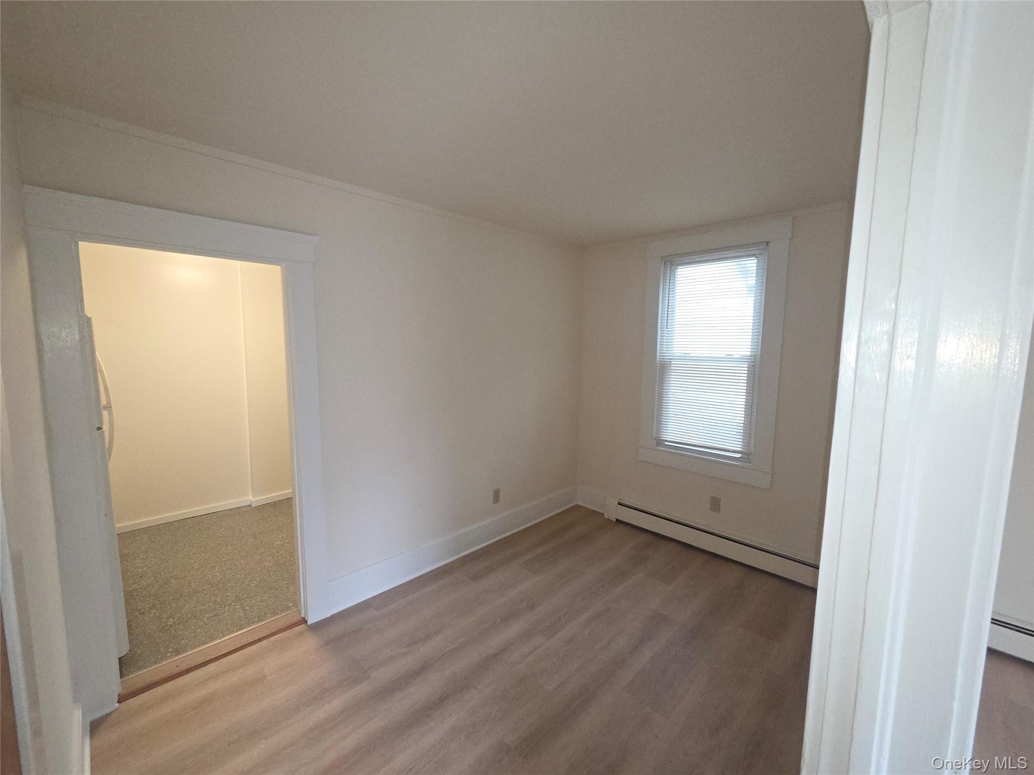 11 Eagle Valley Road, Unit 7 Sloatsburg, NY 10974 - Photo 7 of 24 an empty room with wooden floor and windows