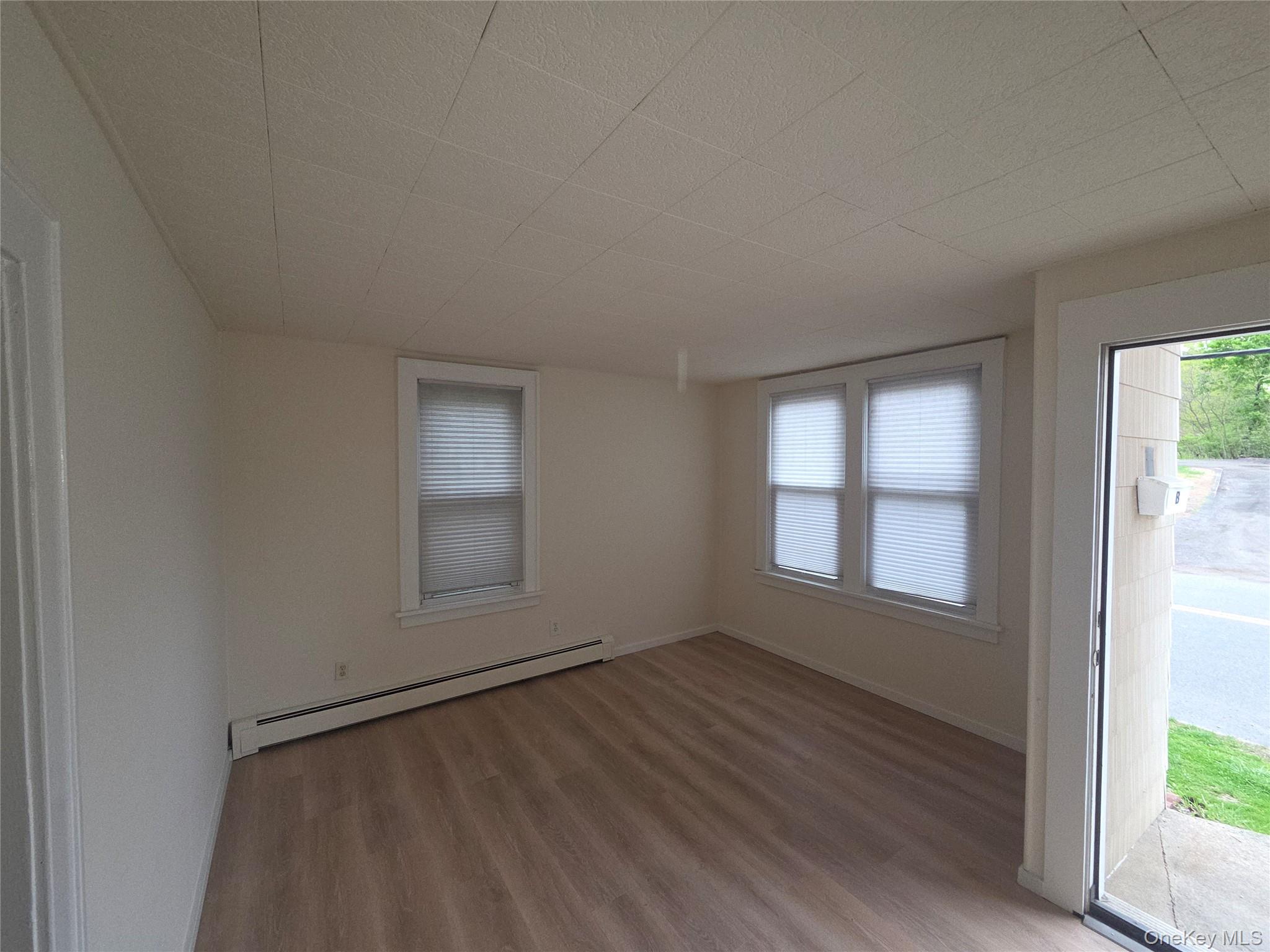 11 Eagle Valley Road, Unit 7 Sloatsburg, NY 10974 - Photo 8 of 24 an empty room with wooden floor and windows