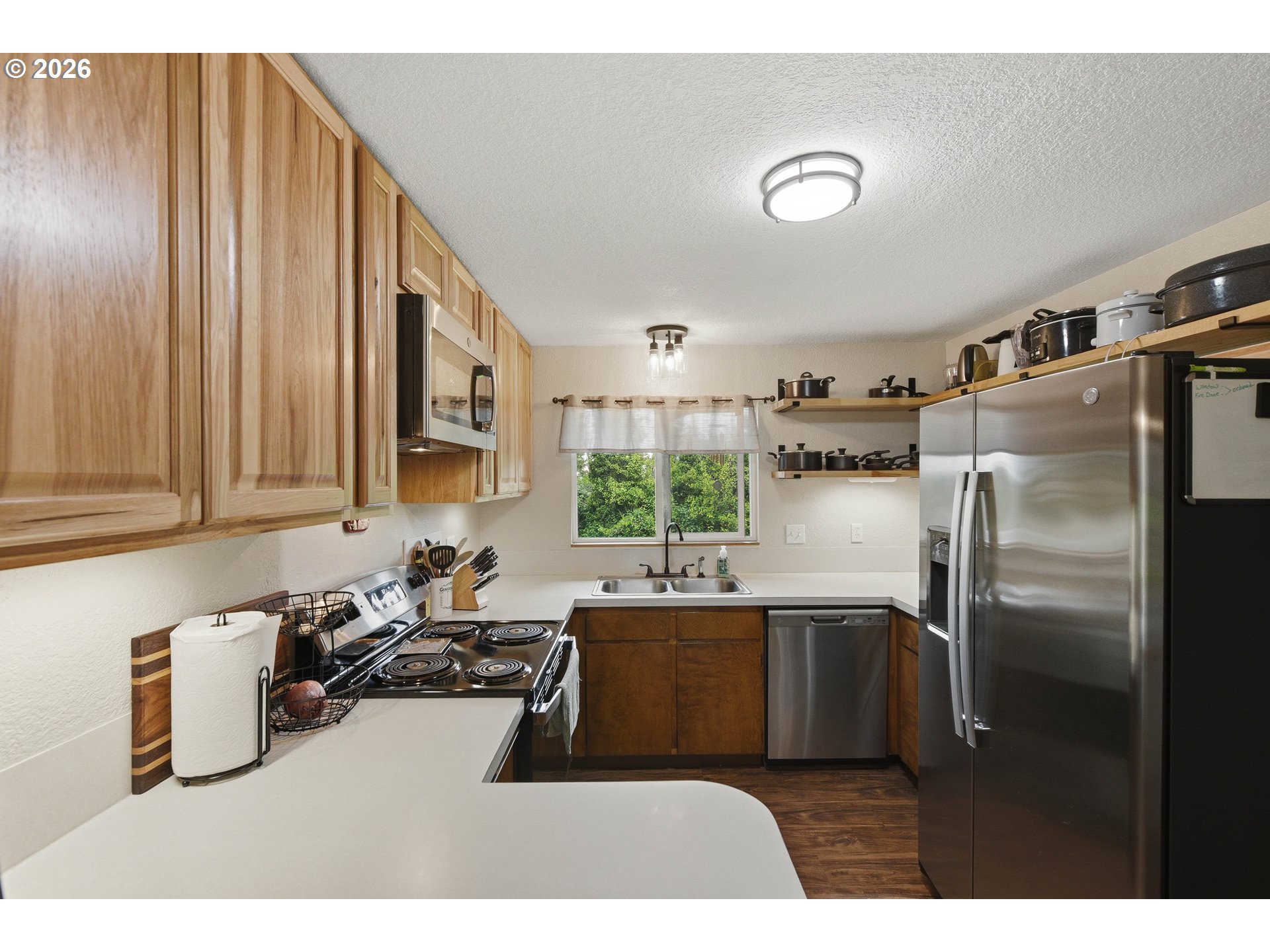 192 North Wood Ridge Road Coquille, OR 97423 - Photo 12 of 42 a kitchen with a refrigerator and a sink