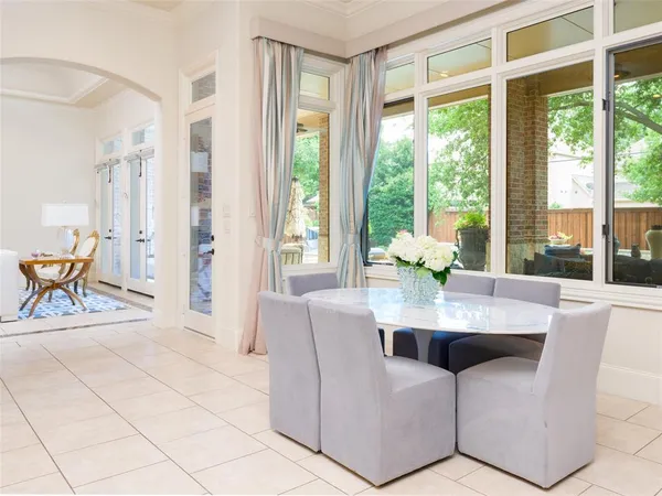 a dining room with furniture and large windows