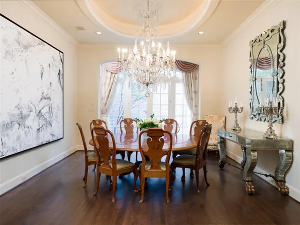 a view of a dining room with furniture wooden floor and chandelier