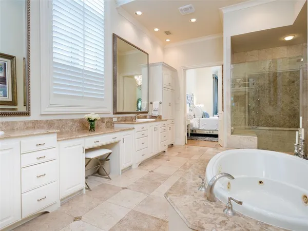 a bathroom with a granite countertop sink mirror and bathtub