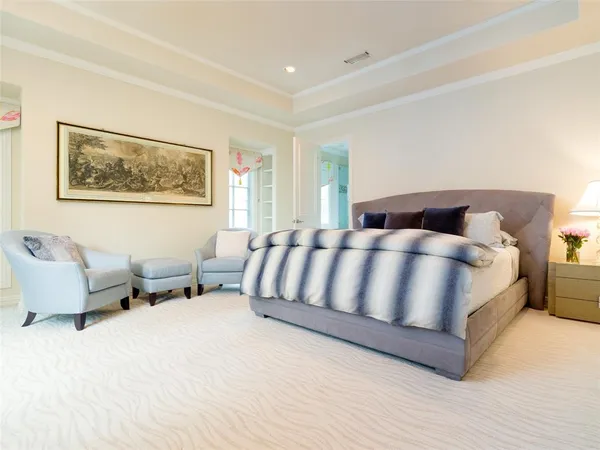 a large bedroom with a bed and window