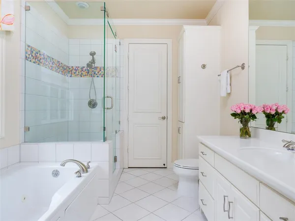 a bathroom with a granite countertop sink a toilet and shower