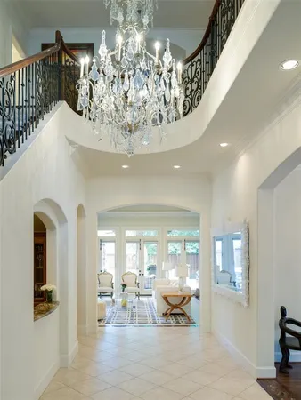 a lobby with furniture and chandelier