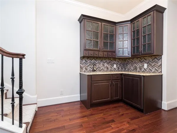 a kitchen with stainless steel appliances granite countertop a sink and wooden floor