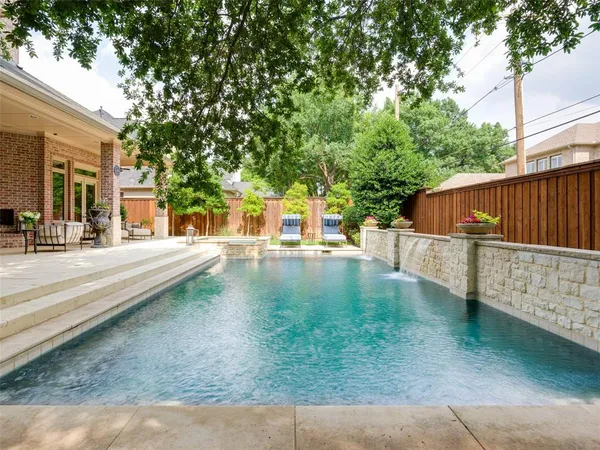 a view of a swimming pool with outdoor seating
