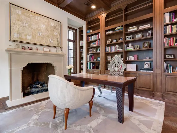 a living room with furniture a bookshelf and a fireplace
