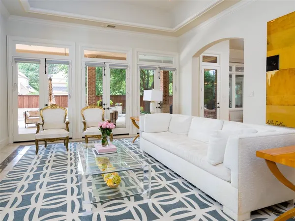 a living room with furniture and a table next to a window