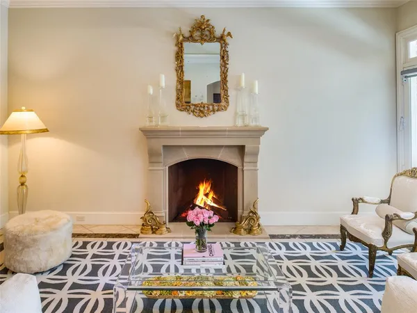 a living room with a rug and a fireplace