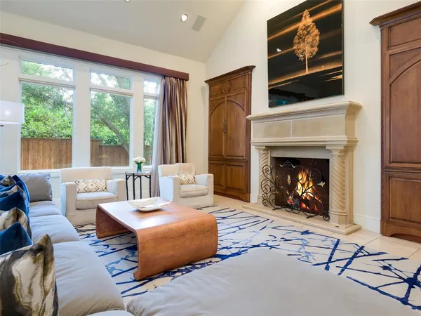 a living room with furniture a fireplace and a flat screen tv