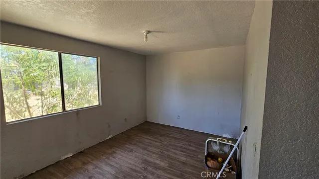 a view of a room with wooden floor and windows