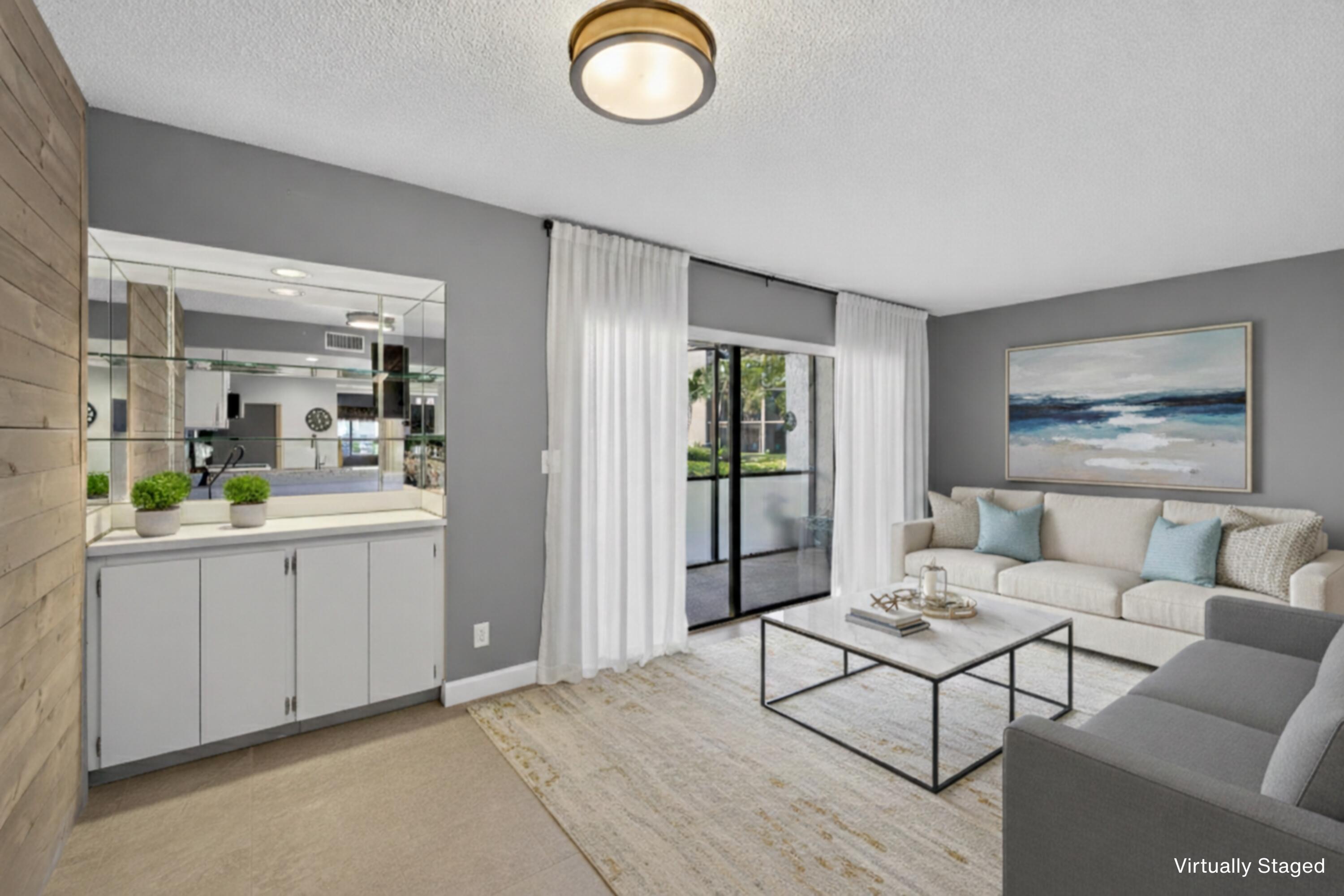 1605 Highway 1, Unit D105 Jupiter, FL 33477 - Photo 2 of 69 a living room with furniture and a table