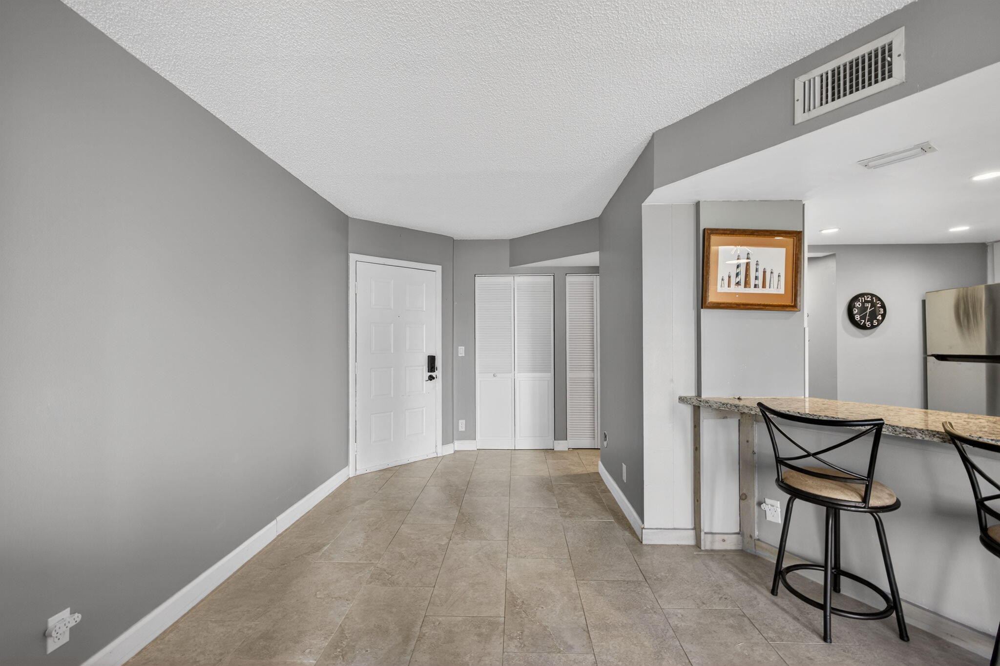 1605 Highway 1, Unit D105 Jupiter, FL 33477 - Photo 25 of 69 a view of a hallway to a livingroom with furniture and window