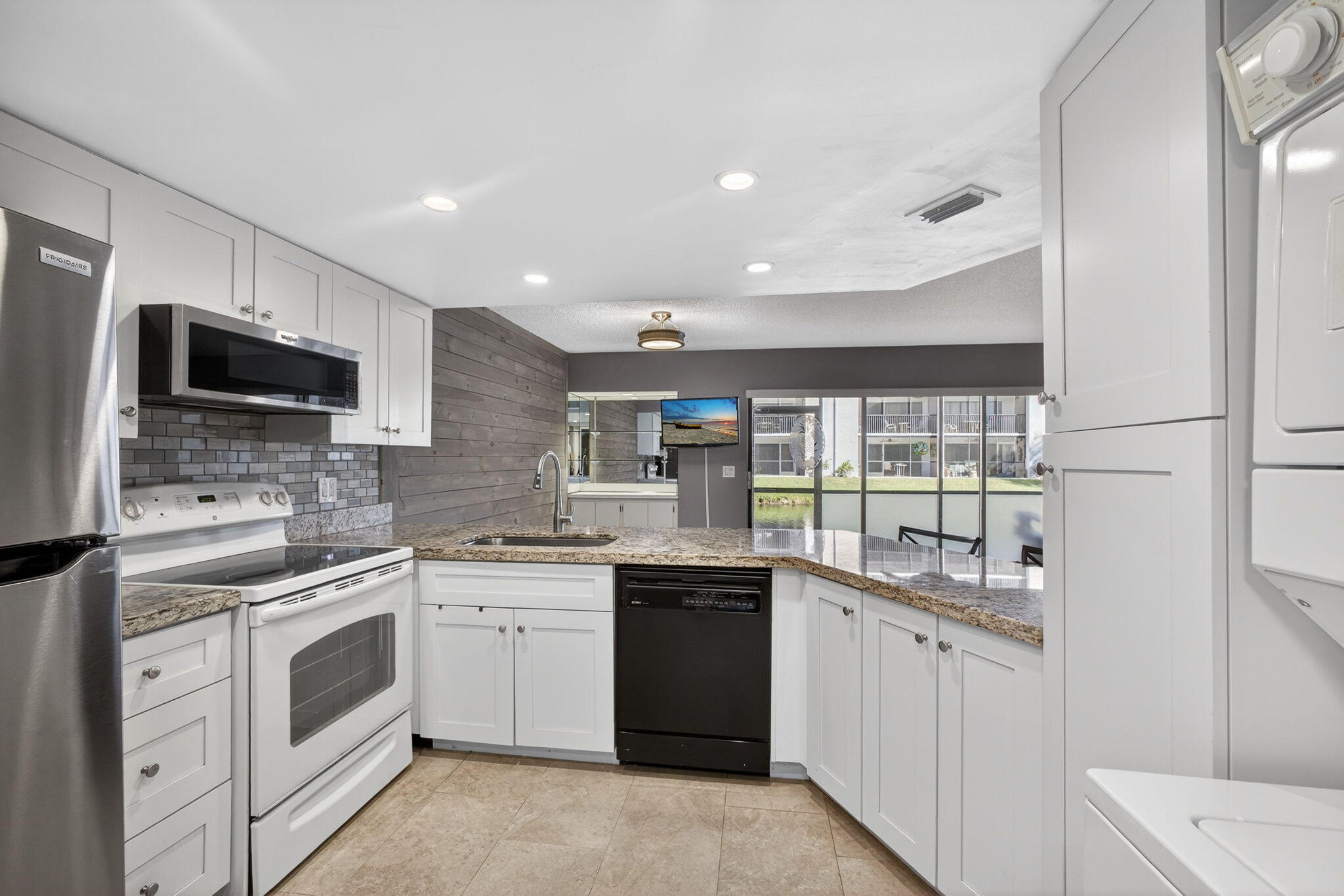 1605 Highway 1, Unit D105 Jupiter, FL 33477 - Photo 7 of 69 a kitchen with a sink stove and microwave